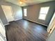 The neutral-colored bedroom is brightly lit with new vinyl flooring, two windows, and a ceiling fan for energy efficiency at 217 Blackburn Blvd, North Port, FL 34287