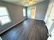 Neutral-colored bedroom is brightly lit with new vinyl flooring, two windows and a ceiling fan for energy efficiency at 217 Blackburn Blvd, North Port, FL 34287