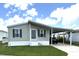 Inviting single-story home with a covered carport and tidy front lawn at 217 Blackburn Blvd, North Port, FL 34287
