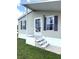 Close up view of the front porch and door with white railings at 217 Blackburn Blvd, North Port, FL 34287