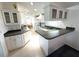 Bright kitchen with white cabinets, tile floors and gray countertop at 217 Blackburn Blvd, North Port, FL 34287