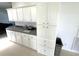 The kitchen features white cabinets and a neutral countertop with a kitchen nook visible in the background at 217 Blackburn Blvd, North Port, FL 34287