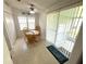 Bright eat-in nook has a ceiling fan, table with seating for four, and sliding glass door to an outdoor porch at 217 Blackburn Blvd, North Port, FL 34287
