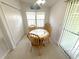 Bright kitchen nook boasts a ceiling fan, table with seating for four, and a sliding glass door to an outdoor porch at 217 Blackburn Blvd, North Port, FL 34287