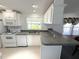 Well-lit kitchen features gray countertop and white cabinets at 217 Blackburn Blvd, North Port, FL 34287