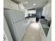 The kitchen features white cabinets and appliances, neutral countertops, and an eat-in space in the background at 217 Blackburn Blvd, North Port, FL 34287