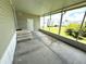 Porch featuring a door, stairs, and screens looking out into the yard at 217 Blackburn Blvd, North Port, FL 34287