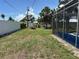Spacious backyard with a screen enclosure, offering ample green space and privacy at 232 Fiesole St, Venice, FL 34285