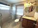 Updated bathroom featuring a glass-enclosed shower, granite countertop vanity, and modern fixtures at 232 Fiesole St, Venice, FL 34285