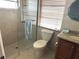 Clean bathroom with a glass-enclosed shower, granite countertop vanity, and modern fixtures at 232 Fiesole St, Venice, FL 34285