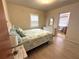 Inviting bedroom with a comfortable bed, a white dresser, and an en-suite bathroom at 232 Fiesole St, Venice, FL 34285
