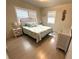 Charming bedroom with a white wicker bed frame, matching dresser, and plantation shutters at 232 Fiesole St, Venice, FL 34285