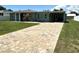 Charming single-story home featuring a paver driveway and well-maintained front lawn at 232 Fiesole St, Venice, FL 34285