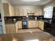 Well-equipped kitchen with granite countertops, wood cabinets, and stainless steel appliances at 232 Fiesole St, Venice, FL 34285