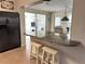 Open-concept kitchen with bar seating, connecting to a dining area and offering ample counter space at 232 Fiesole St, Venice, FL 34285