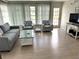 Comfortable living room with light wood floors and large windows, creating a bright and airy atmosphere at 232 Fiesole St, Venice, FL 34285