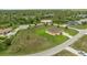 Expansive aerial shot of yellow home, large lawn with palm trees, long driveway, and surrounding wooded area at 2479 Grandview Dr, North Port, FL 34288