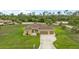 Attractive home with well-manicured landscaping, a three-car garage, and a charming exterior design at 2479 Grandview Dr, North Port, FL 34288