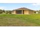 Grassy backyard boasts a screened lanai, providing ample space for recreation and leisure in a serene setting at 2479 Grandview Dr, North Port, FL 34288