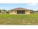 Spacious backyard features a well-maintained lawn and a screened lanai, ideal for relaxation and outdoor enjoyment at 2479 Grandview Dr, North Port, FL 34288