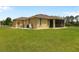 Expansive backyard with lush lawn and screened lanai, offering the perfect space for outdoor activities and entertaining at 2479 Grandview Dr, North Port, FL 34288
