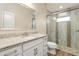 Well-lit bathroom featuring granite countertops, a glass-enclosed shower, and modern fixtures for a luxurious feel at 2479 Grandview Dr, North Port, FL 34288