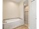 Bright bathroom featuring a tiled soaking tub and a tiled walk-in shower with glass doors at 2479 Grandview Dr, North Port, FL 34288