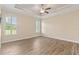 Empty bedroom features wood floors, arched windows with plantation shutters, and a ceiling fan at 2479 Grandview Dr, North Port, FL 34288
