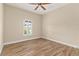 Inviting bedroom with wood floors, arched window, and ceiling fan offers a serene and comfortable space at 2479 Grandview Dr, North Port, FL 34288