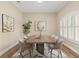 Dining room with table, rug, modern décor and window with plantation shutters at 2479 Grandview Dr, North Port, FL 34288