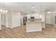 Open kitchen with white cabinetry, stainless appliances, and breakfast bar at 2479 Grandview Dr, North Port, FL 34288