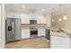 Bright kitchen with stainless appliances, granite countertops, and wood look flooring at 2479 Grandview Dr, North Port, FL 34288