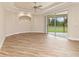 Spacious living area boasts wood floors, neutral walls, tray ceiling and a sliding glass door to the outside at 2479 Grandview Dr, North Port, FL 34288