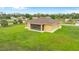 A peaceful rear exterior of home, featuring a screened lanai and spacious backyard, perfect for quiet relaxation and entertainment at 2479 Grandview Dr, North Port, FL 34288