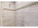 Close up of shower featuring tile walls with decorative mosaic accents and rainfall shower head at 2479 Grandview Dr, North Port, FL 34288
