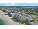 Stunning aerial view of beachfront condos featuring a pool, with city and ocean views at 255 The Esplanade N # 106, Venice, FL 34285