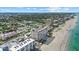 Scenic aerial view of the beachfront condo, pool, beach, and surrounding neighborhood at 255 The Esplanade N # 106, Venice, FL 34285
