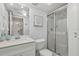Clean and modern bathroom featuring a walk-in shower with glass door and marble counter tops at 255 The Esplanade N # 106, Venice, FL 34285