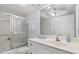 Bright bathroom with a glass-enclosed shower, sleek vanity, and ample mirror space at 255 The Esplanade N # 106, Venice, FL 34285