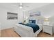 Comfortable bedroom featuring a queen-size bed with white linens and accent pillows, plus stylish decor at 255 The Esplanade N # 106, Venice, FL 34285