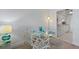 Dining area featuring a glass table, ornate chairs, and views into the kitchen at 255 The Esplanade N # 106, Venice, FL 34285