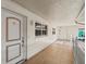 Hallway leading to condo with tile floors and white walls at 255 The Esplanade N # 106, Venice, FL 34285
