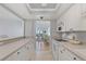 Bright kitchen with white cabinetry and appliances offering a view of the dining area and ocean at 255 The Esplanade N # 106, Venice, FL 34285