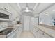Well-maintained kitchen with white cabinets, modern appliances, and ample counter space at 255 The Esplanade N # 106, Venice, FL 34285