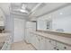 Well-maintained kitchen with white cabinets, modern appliances, and ample counter space at 255 The Esplanade N # 106, Venice, FL 34285