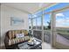 Enclosed lanai offering scenic views of the beach and nearby greenery at 255 The Esplanade N # 106, Venice, FL 34285