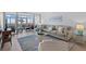 Comfortable living room with a plush sofa and large windows overlooking the beach at 255 The Esplanade N # 106, Venice, FL 34285