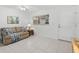 Bright living room featuring a sofa, throw pillows, and tile flooring at 255 The Esplanade N # 106, Venice, FL 34285