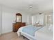 Tranquil bedroom with a ceiling fan, dresser, and soft bedding at 255 The Esplanade N # 106, Venice, FL 34285