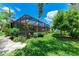 Beautiful backyard with a screened-in patio, lush landscaping, and a well-maintained lawn at 2944 Oriole Dr, Sarasota, FL 34243